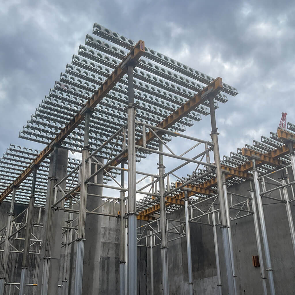 Wichita BNR | E-Z DECK® handled heavier-load walkway areas while Bridge Overhang Brackets covered lighter sections as the more economical option, with simple wood side forms closing the perimeter of the 10-inch slab.