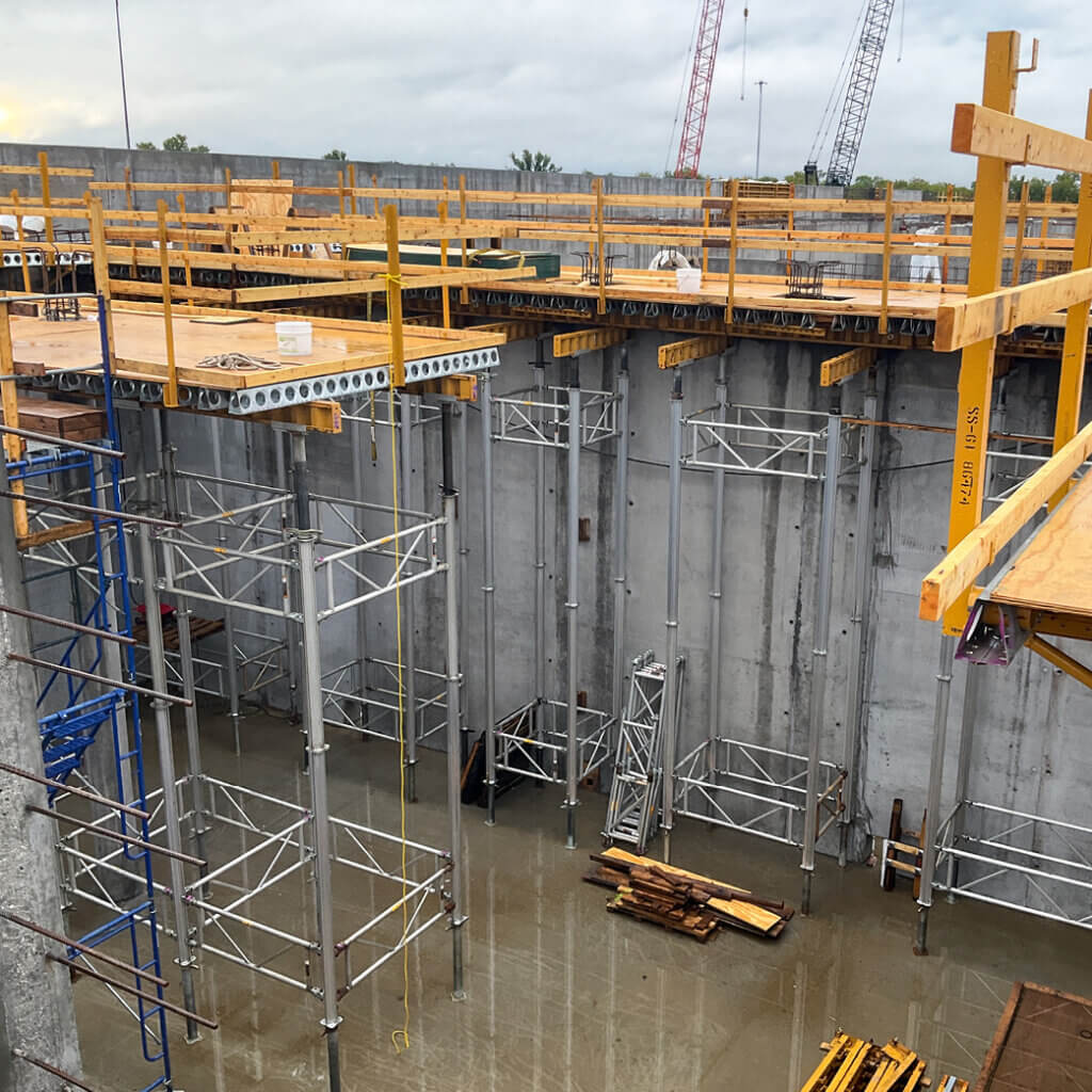 Wichita BNR | E-Z DECK® handled heavier-load walkway areas while Bridge Overhang Brackets covered lighter sections as the more economical option, with simple wood side forms closing the perimeter of the 10-inch slab.