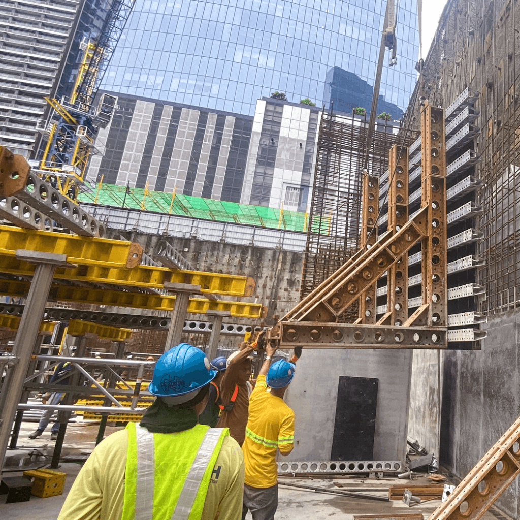 Pre-assembled wall sections allowed crews to install lengthy spans of formwork in a single day, demonstrating how thoughtful staging accelerates concrete operations on complex sites.
